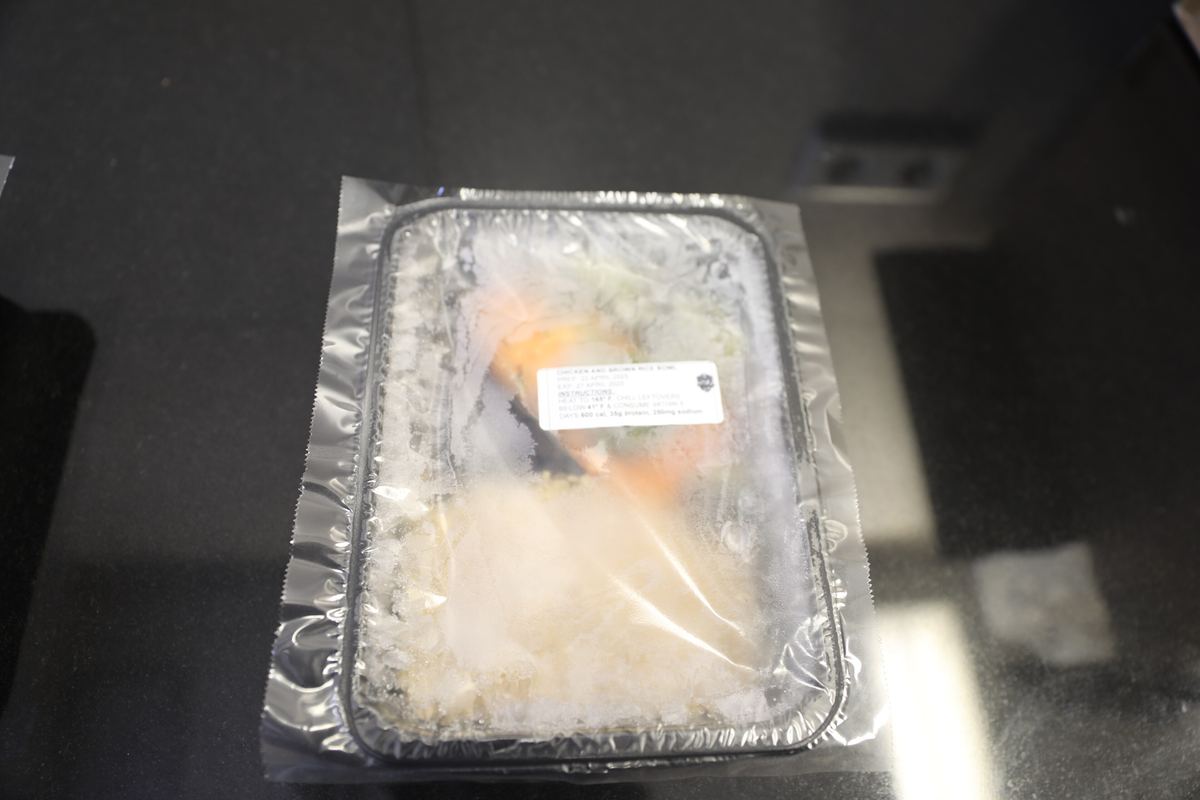 Packed meal-prep container with portioned food