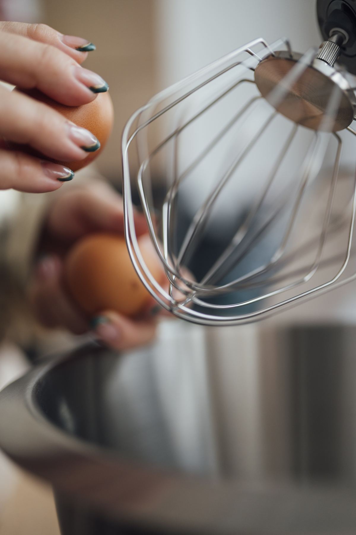 Person whisking eggs in a bowl while preparing a meal