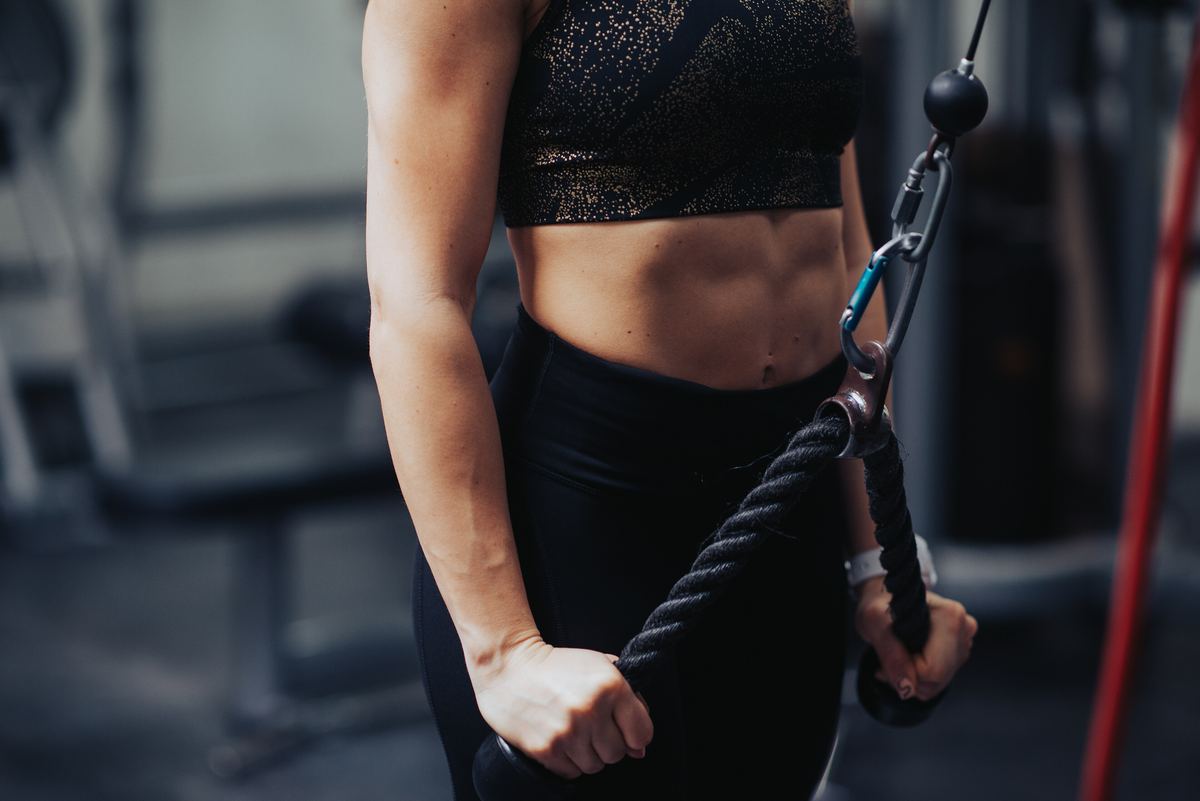 Woman using a cable machine for an upper-body exercise
